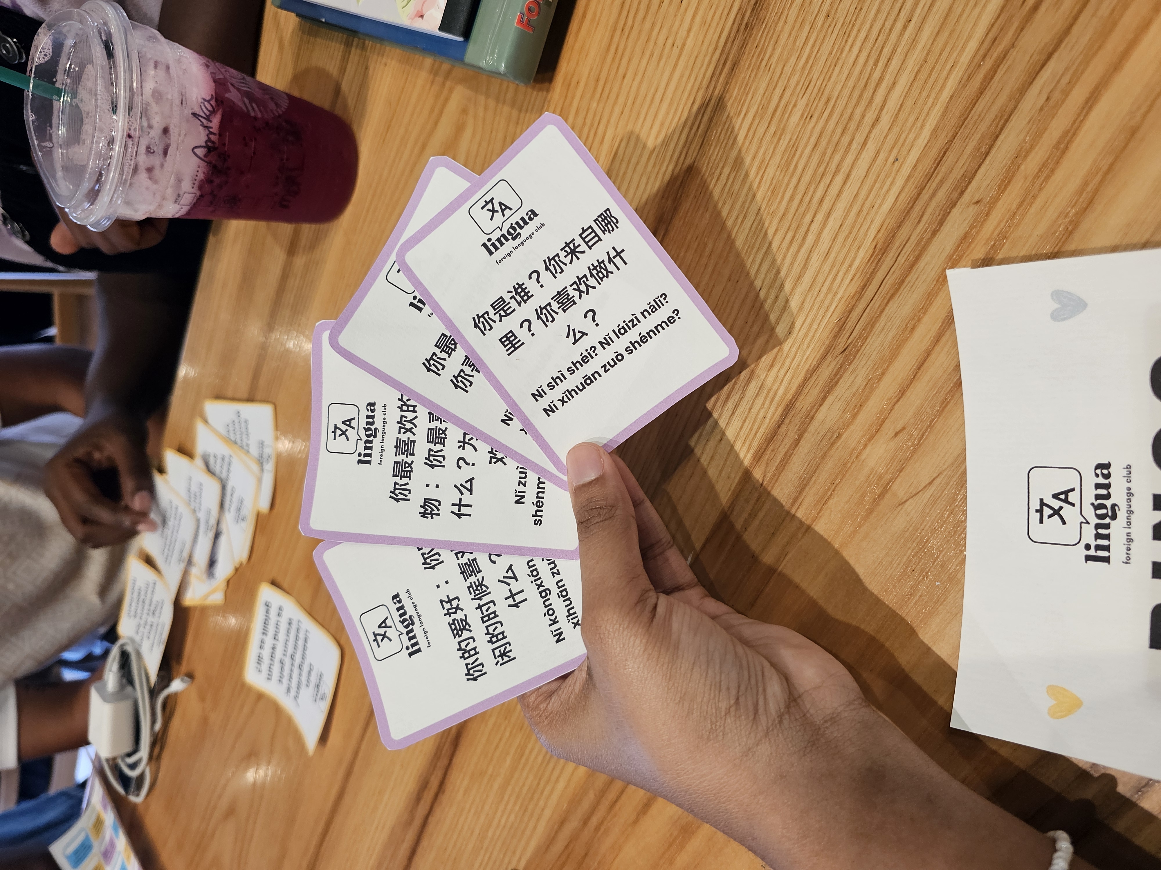 Language cards in hand at lingua event
